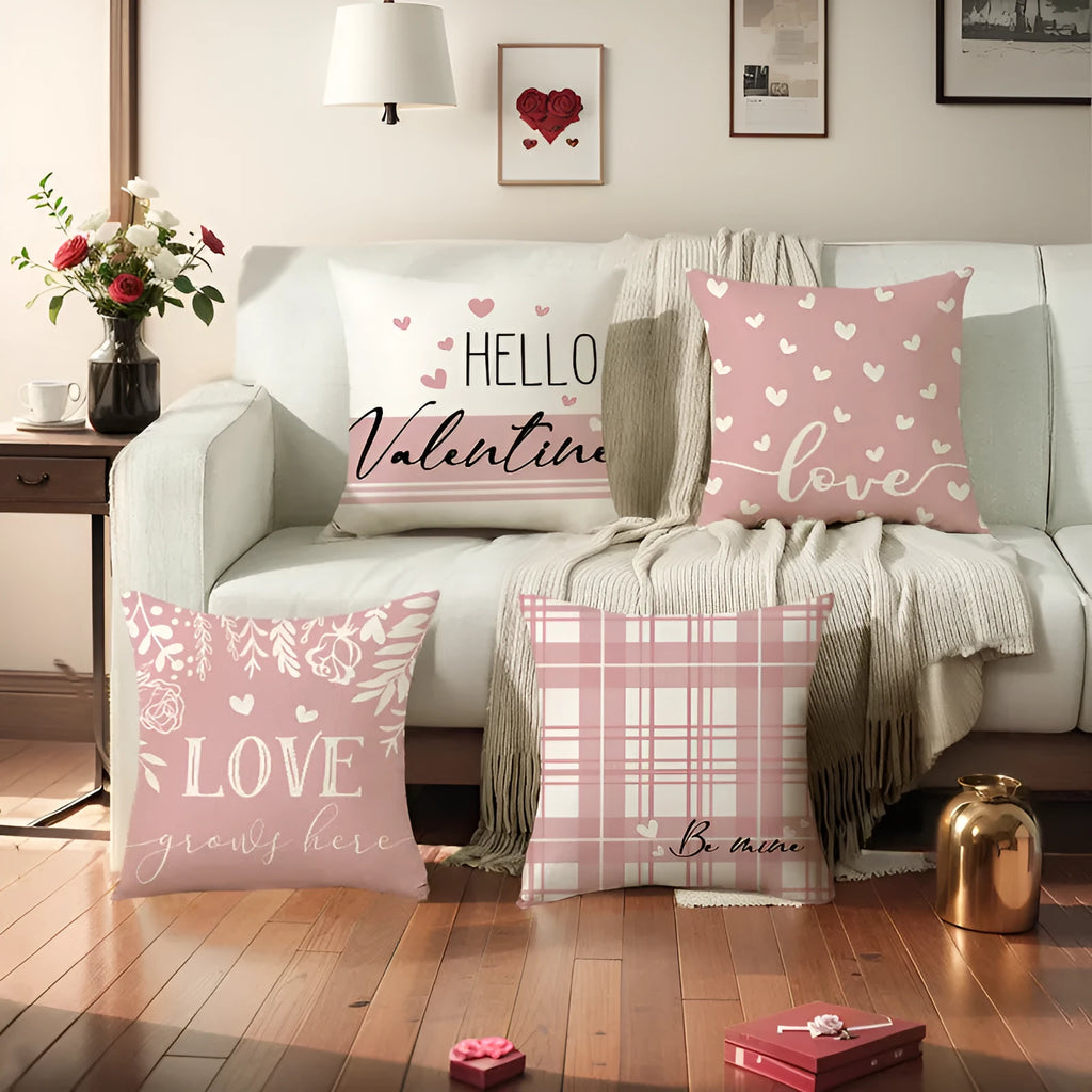 Square red and black plaid pillow cover with white heart shapes, resting on a grey sofa.