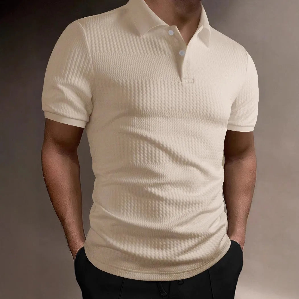 Man wearing a loose-fit striped polo shirt in a light blue colour, showing asymmetric detail and short sleeves.