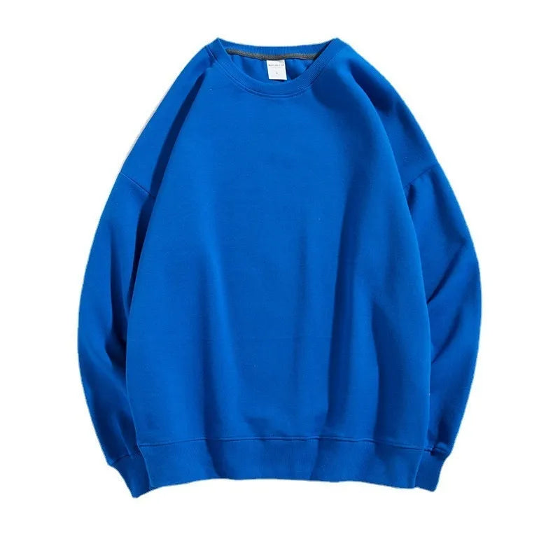 A woman's loose cotton off-shoulder sweater in a solid colour with long sleeves.
