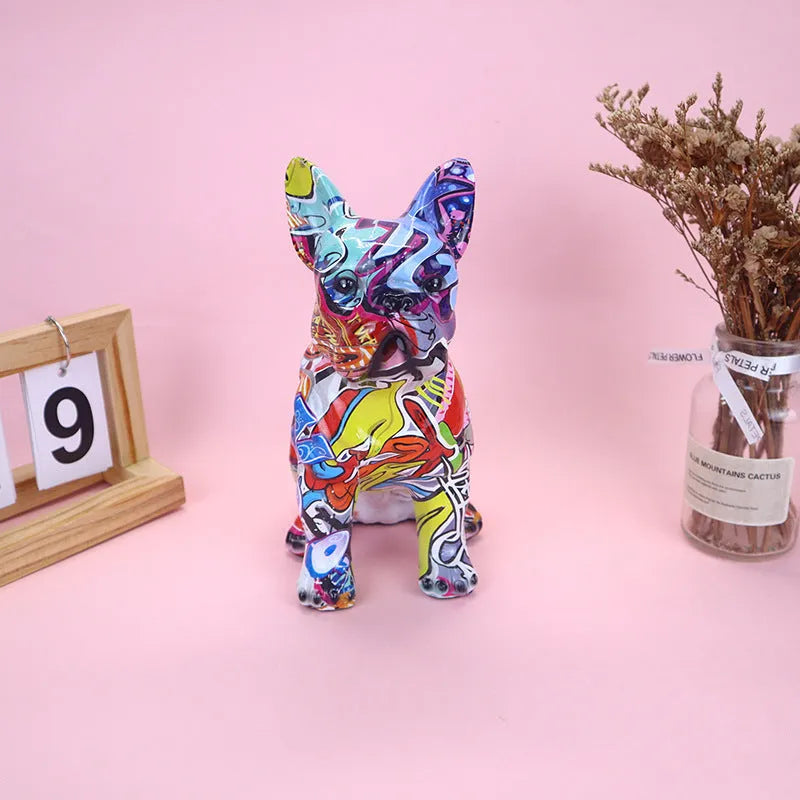 Graffiti-coloured French Bulldog resin statue on display surface