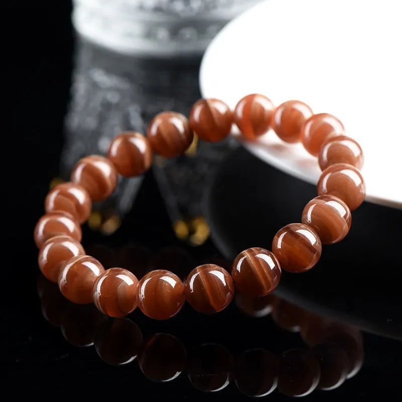 Natural Peruvian rhodochrosite bead bracelet in old mine colour, showing round 8mm beads.