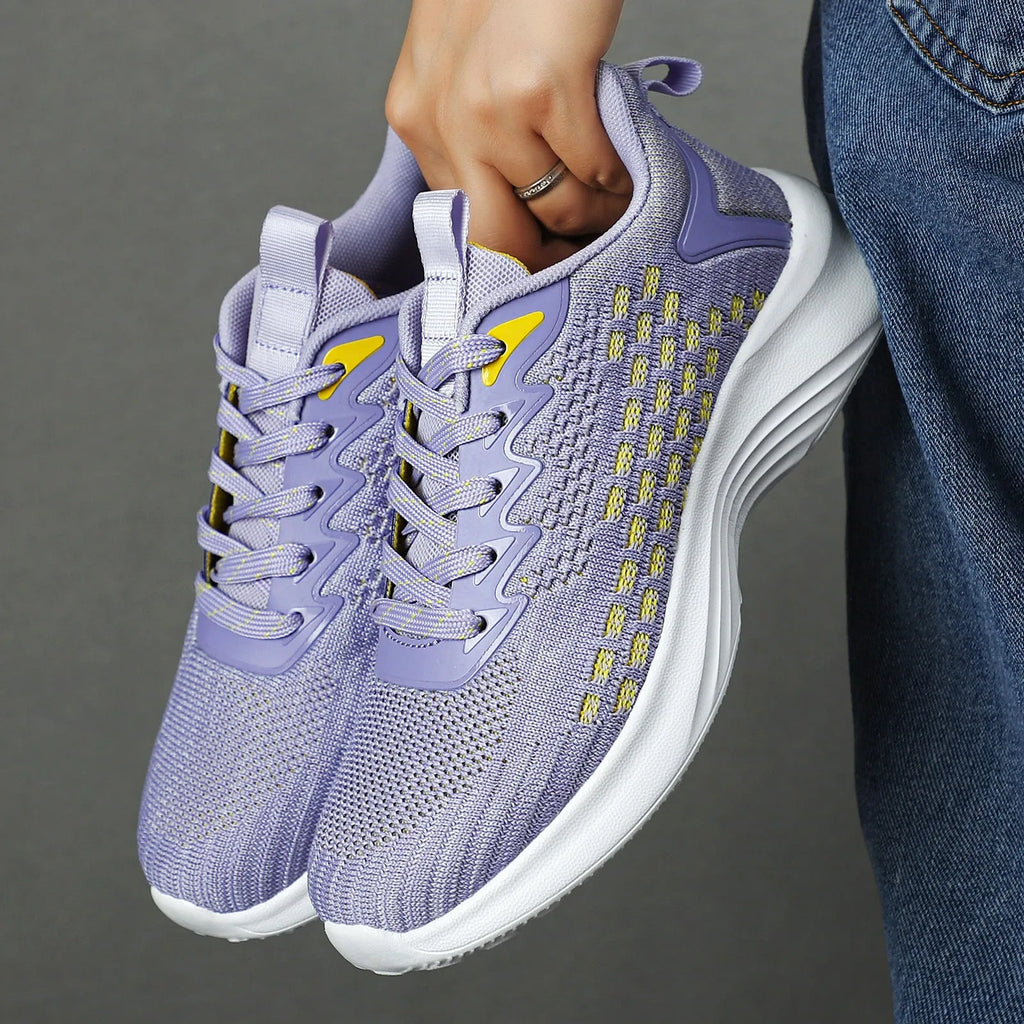 Women's Lavender Purple Flyknit running shoes with mesh detailing and a striped pattern on a white background.