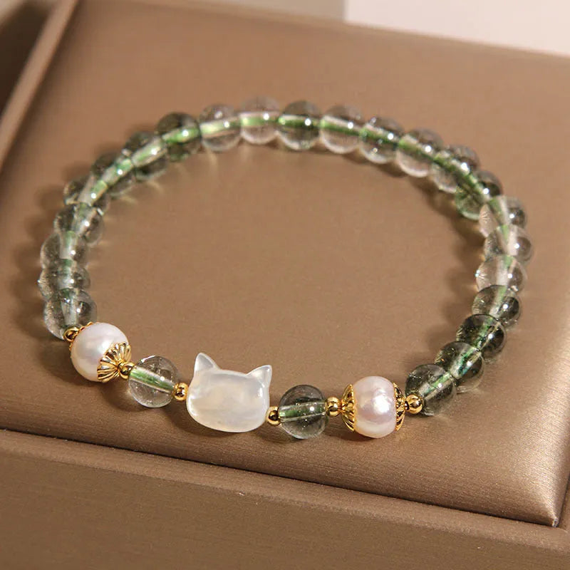 Green phantom quartz bracelet with shell kitten charm on wrist