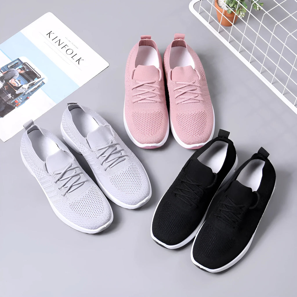 Women's black lace-up casual sneakers with a mesh upper and a textured non-slip PVC sole.