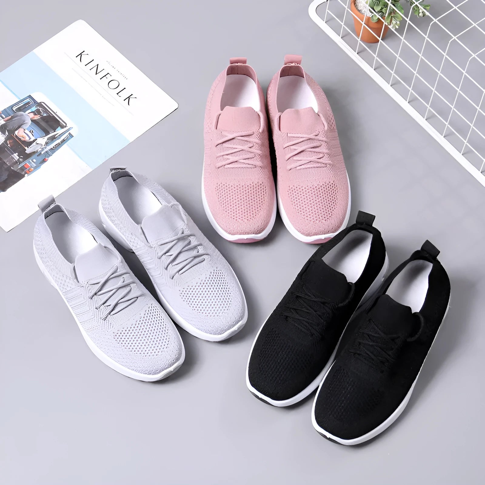 Women's black lace-up casual sneakers with a mesh upper and a textured non-slip PVC sole.