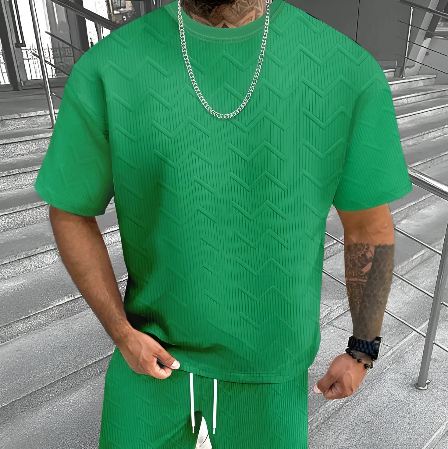 Man wearing a short sleeve printed top with matching shorts from a men's leisure suit set.