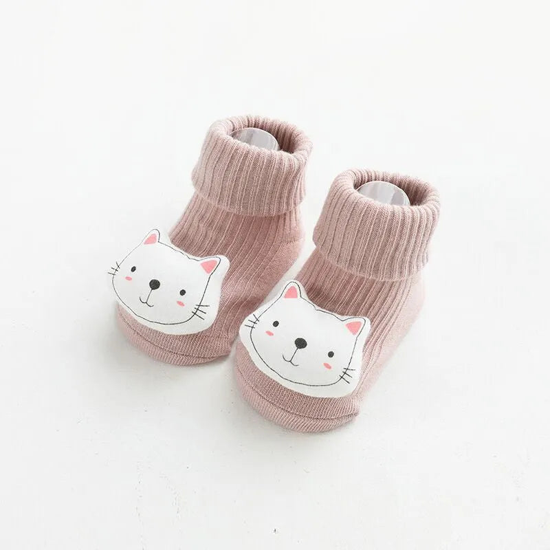 Pair of light grey baby socks with white non-slip silicone grip dots on the soles.