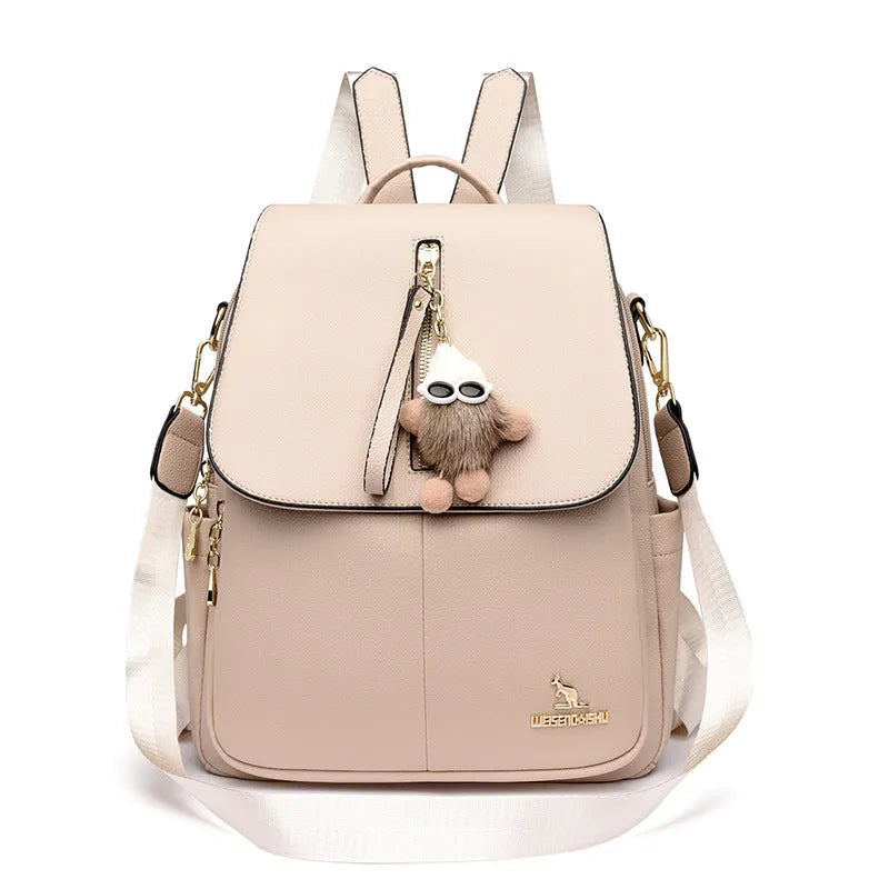 Genuine leather travel backpack with pendant in beige colour for female students, featuring belt decoration and splicing details