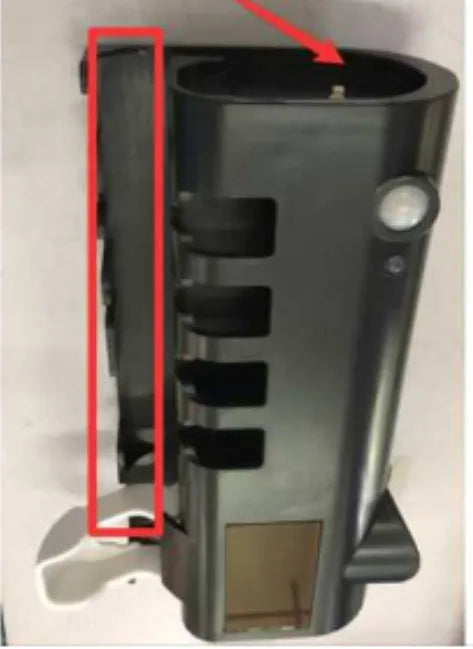 Black wall-mounted UV toothbrush steriliser with automatic toothpaste squeezer on bathroom tiles