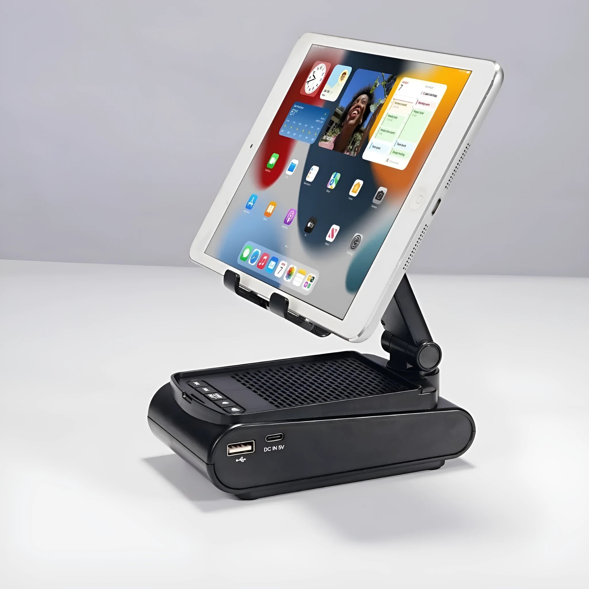Multi-function plastic lazy phone holder with built-in Bluetooth speaker, USB powered, black colour, showing phone in stand