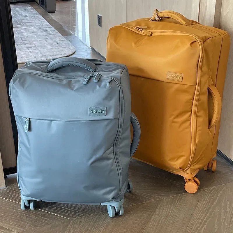 Ultra-light waterproof Oxford cloth suitcase in bluestone green with universal wheels, shown in 20-inch size
