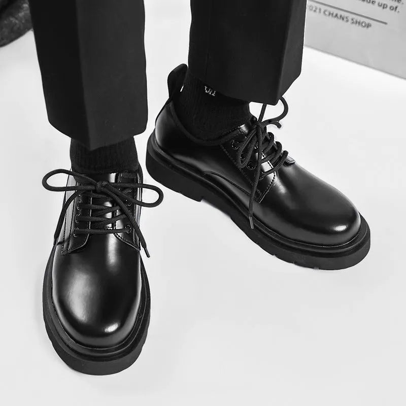 Men's black round-toe leather shoes with thick rubber sole and lace-up closure