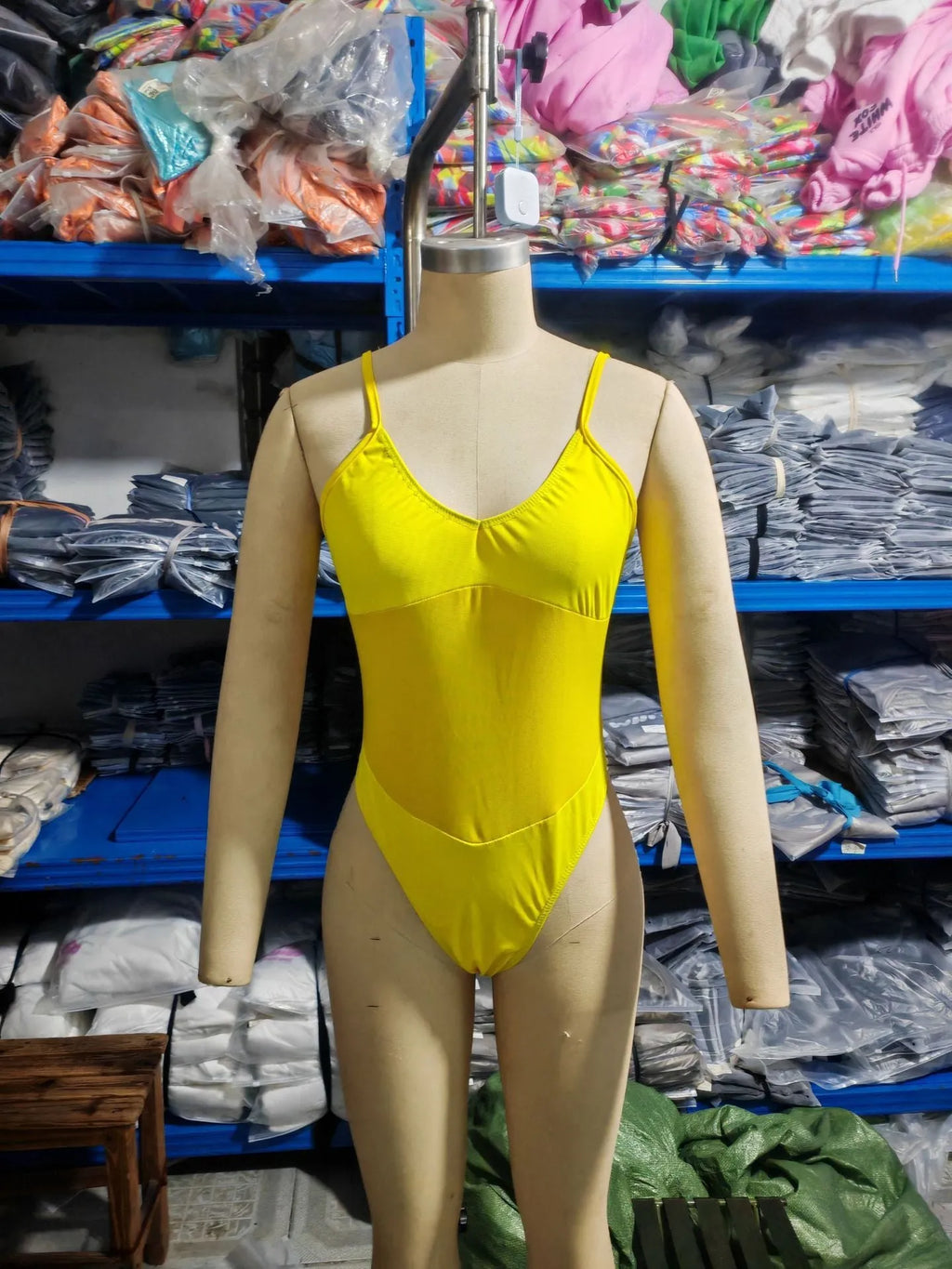 Black solid colour one-piece swimsuit with a sleeveless, banded design on a mannequin.