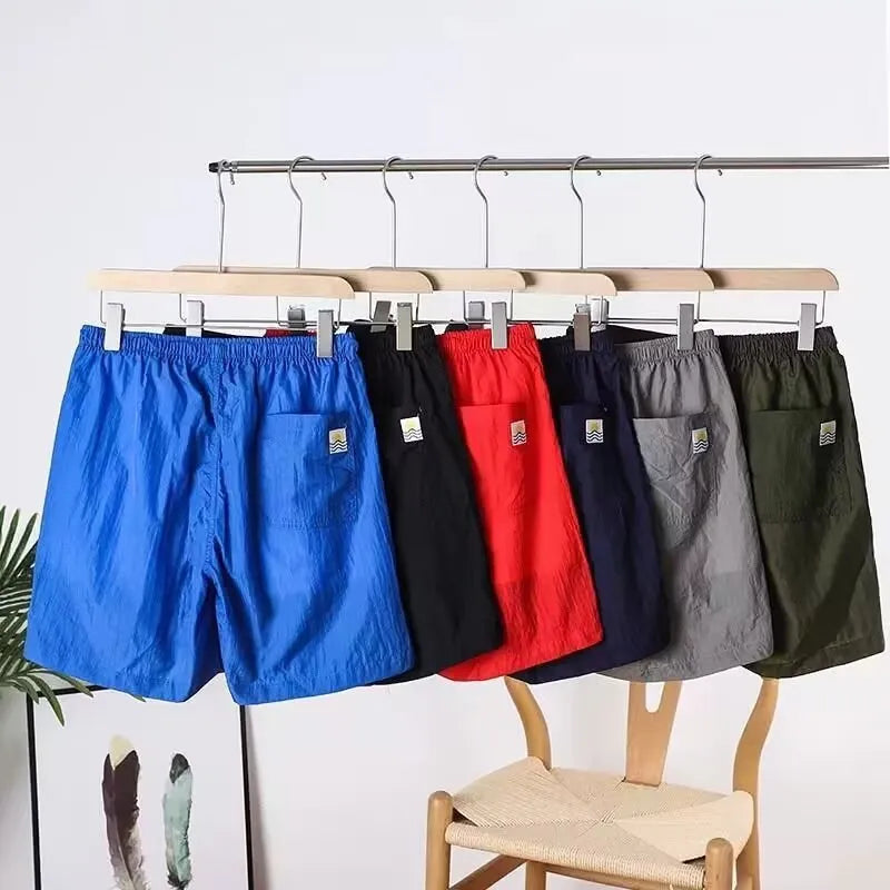 Men's quick-drying polyester sports shorts in straight cut design with chemical fibre blend