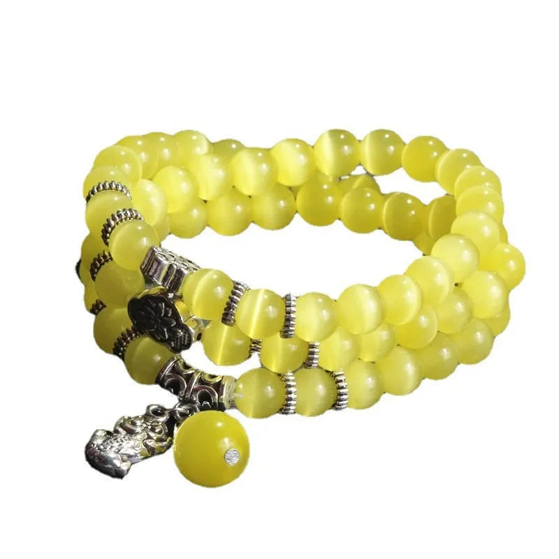 Women's opal bracelet with lucky cat charm, shown in a triple-wrap style with colourful geometric beads.