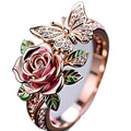Close-up of an adjustable alloy butterfly ring with colourful oil-drip finish and floral details.