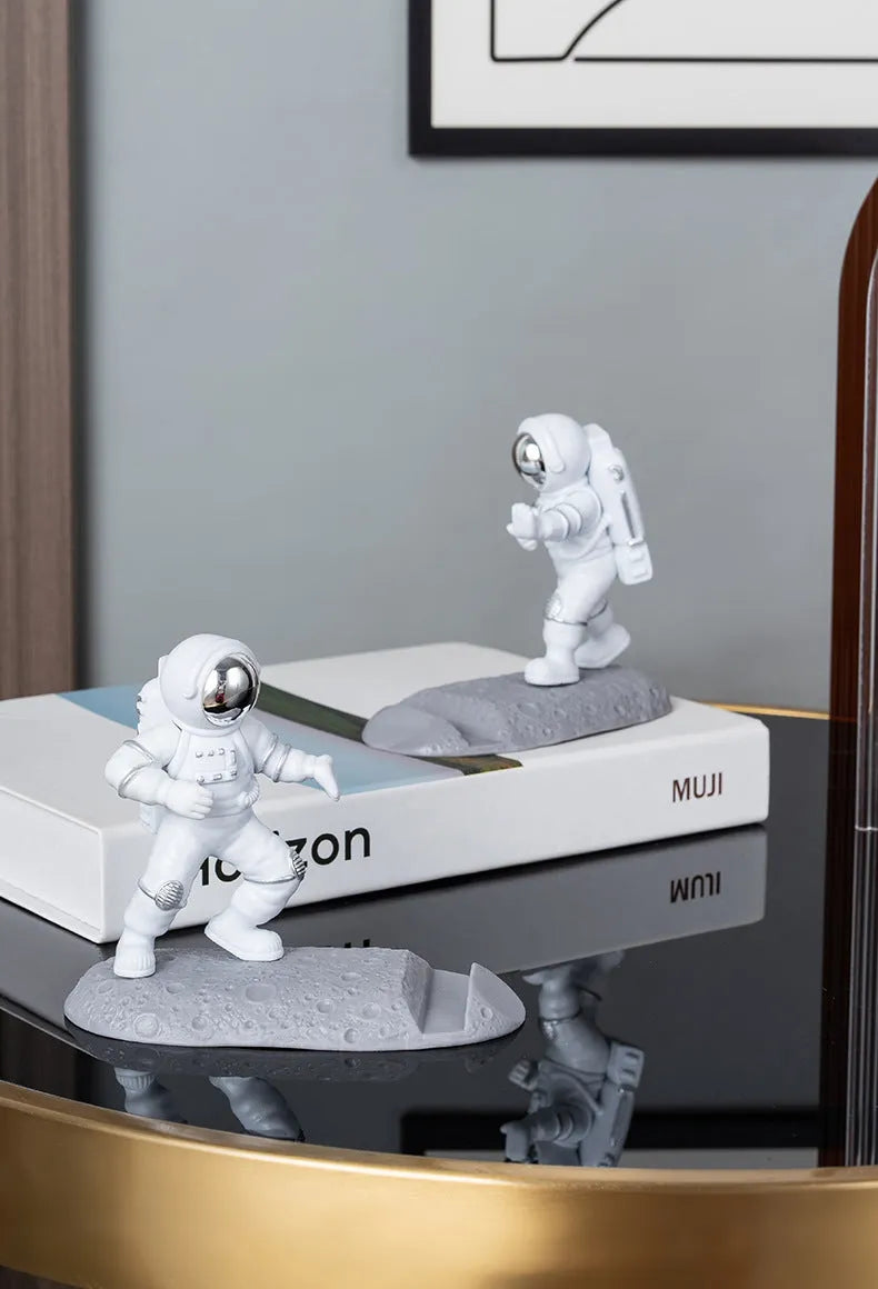 Astronaut decoration spaceman plastic mobile phone holder in blue, gold, and silver colours for lazy binge-watching