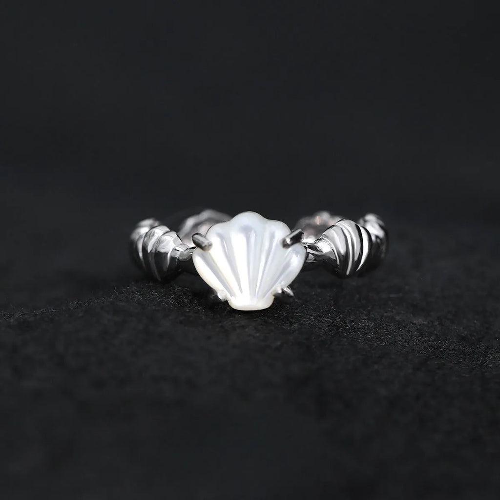 Adjustable silver ring with a white shell and tiger eye stone, featuring an electroplated gold finish.
