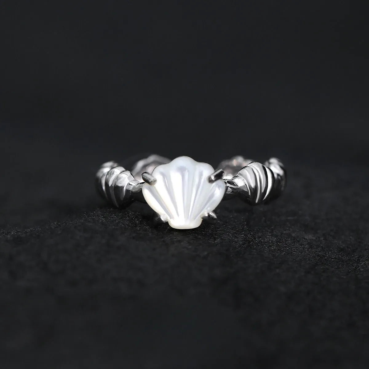 Adjustable silver ring with a white shell and tiger eye stone, featuring an electroplated gold finish.