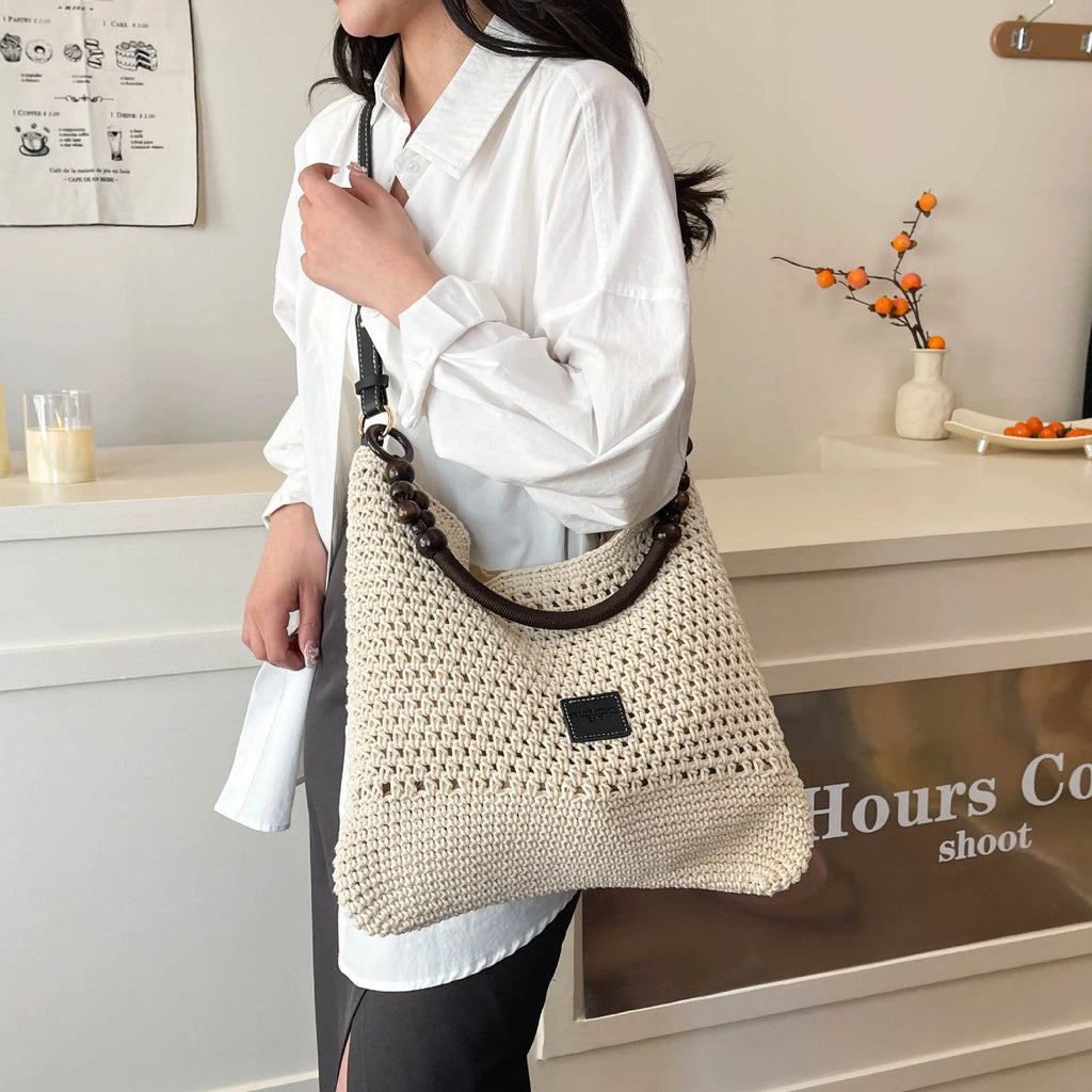Knitted bucket tote beach bag in black or brown with contrast stitching and crossbody strap