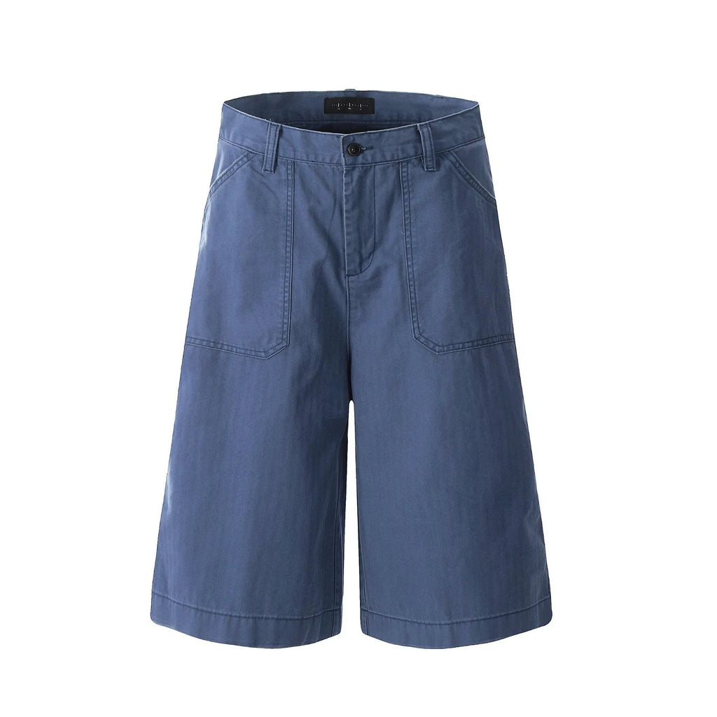 Men's French blue cotton shorts, loose straight-leg fit, mid-rise waist with zipper fly, lying flat.