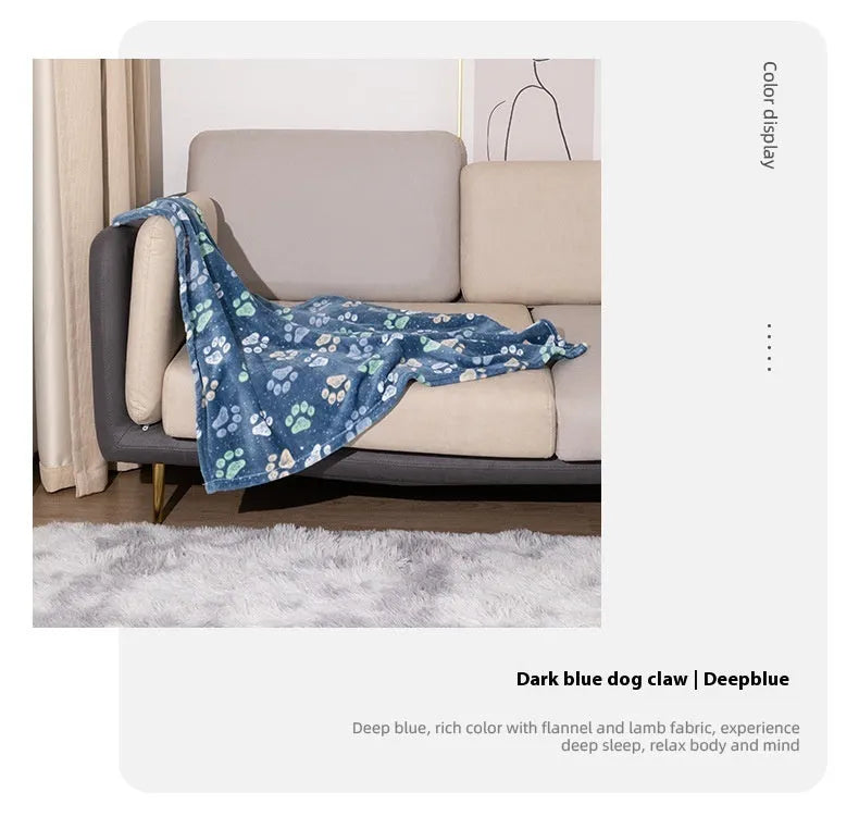Blue cartoon dog paw print pattern on a thick double-sided flannel pet blanket laid flat.