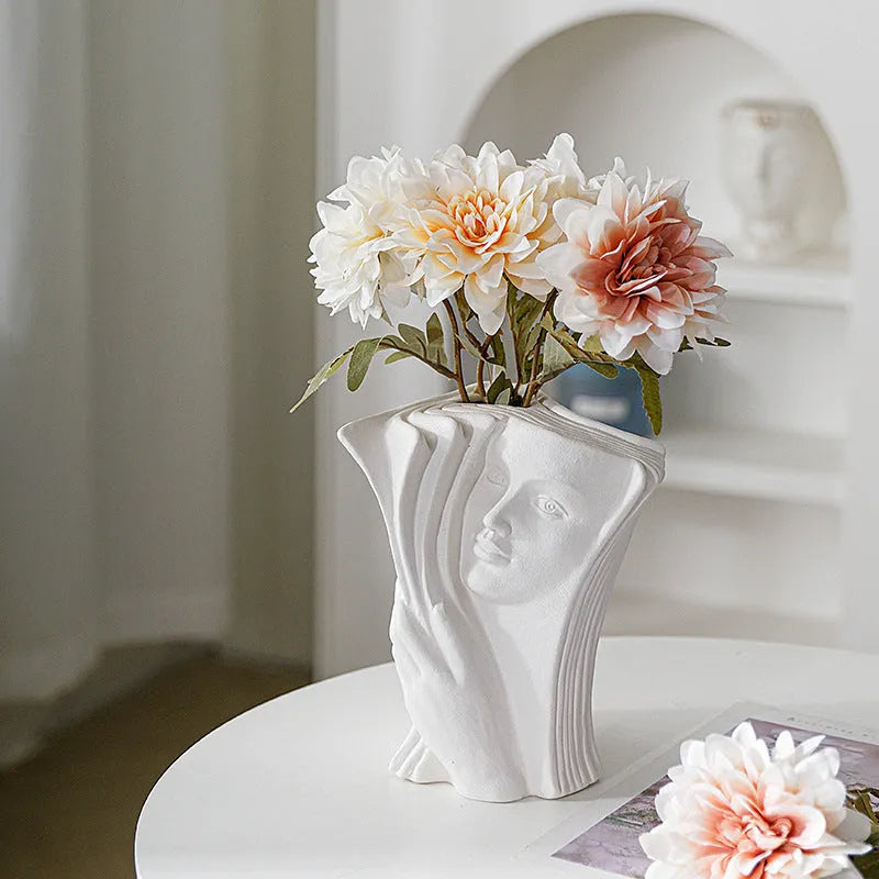 Glazed ceramic book stand ornament in one of four decorative styles on a wooden desk.