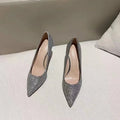 Silver and black women's stiletto bridal shoes with crystal detail on a 9cm heel.