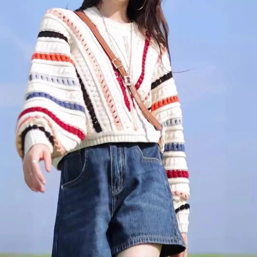 Colourful rainbow striped loose-fit pullover sweater with batwing sleeves and a round neck.