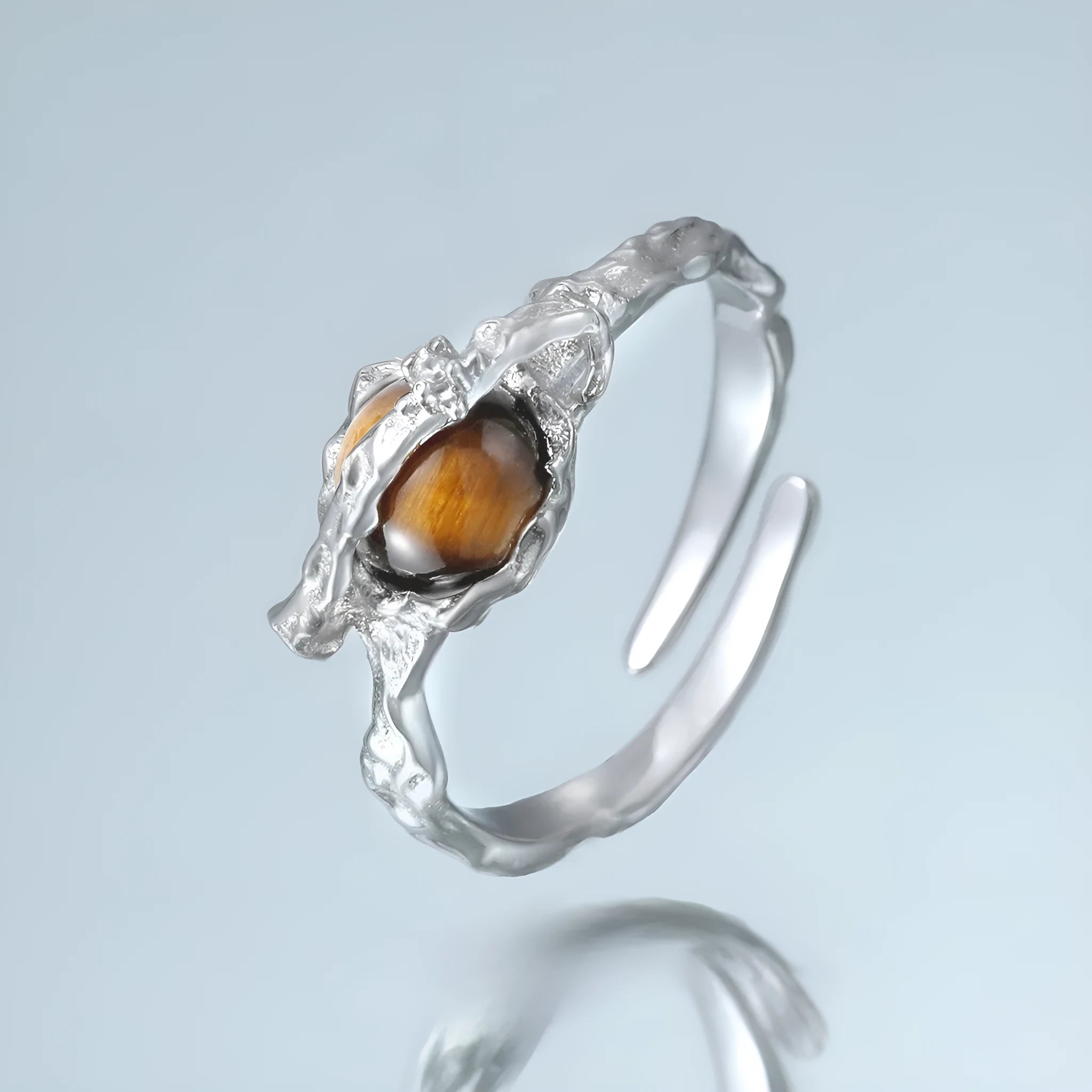 Silver open ring with Saturn design and white gold plating, shown with adjustable opening.