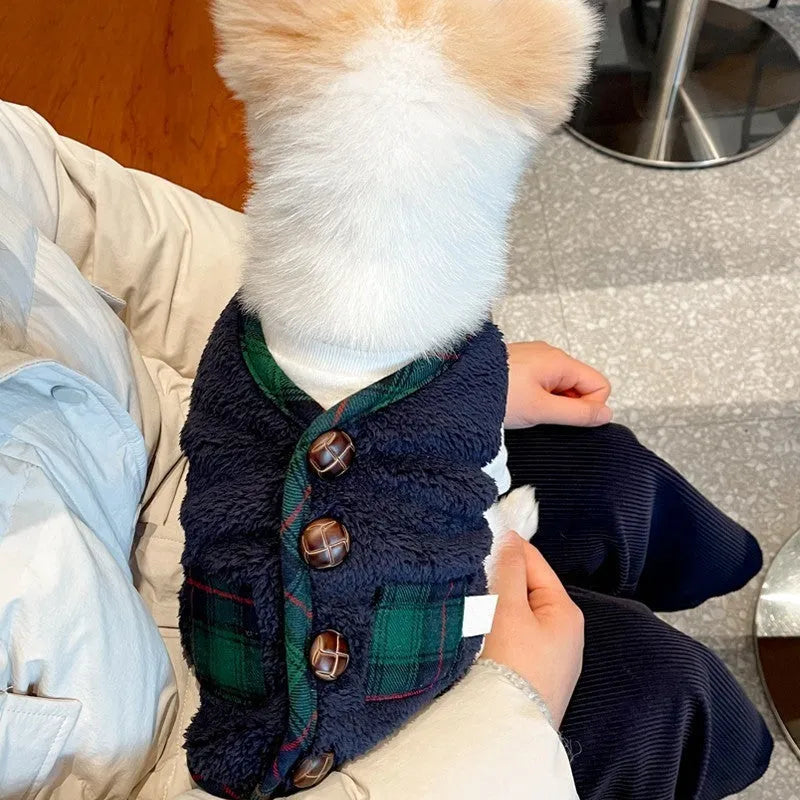 Navy blue pet fleece jacket with checkered pattern, Sherpa lining, decorative buttons, and snowman accent on a small dog