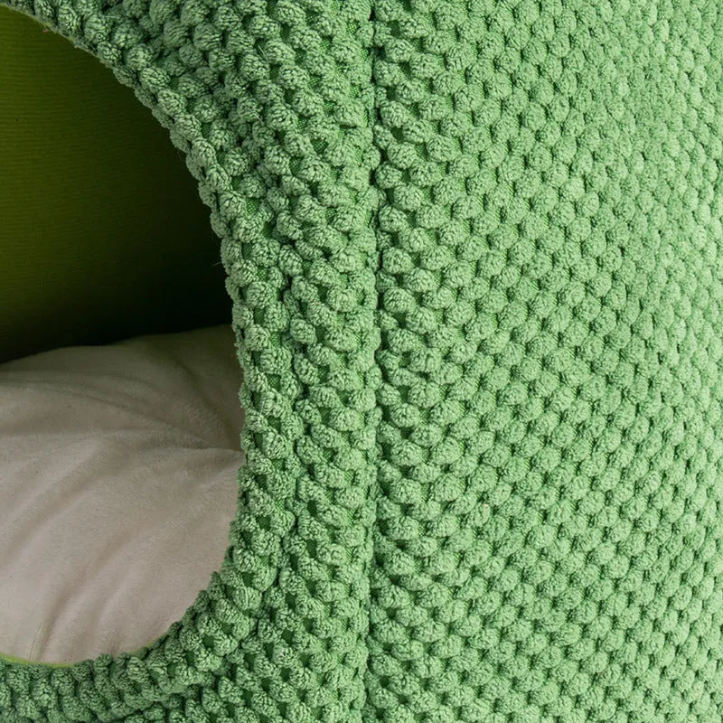 Dark green cactus-shaped enclosed cat bed with a soft interior, shown with a green accent.