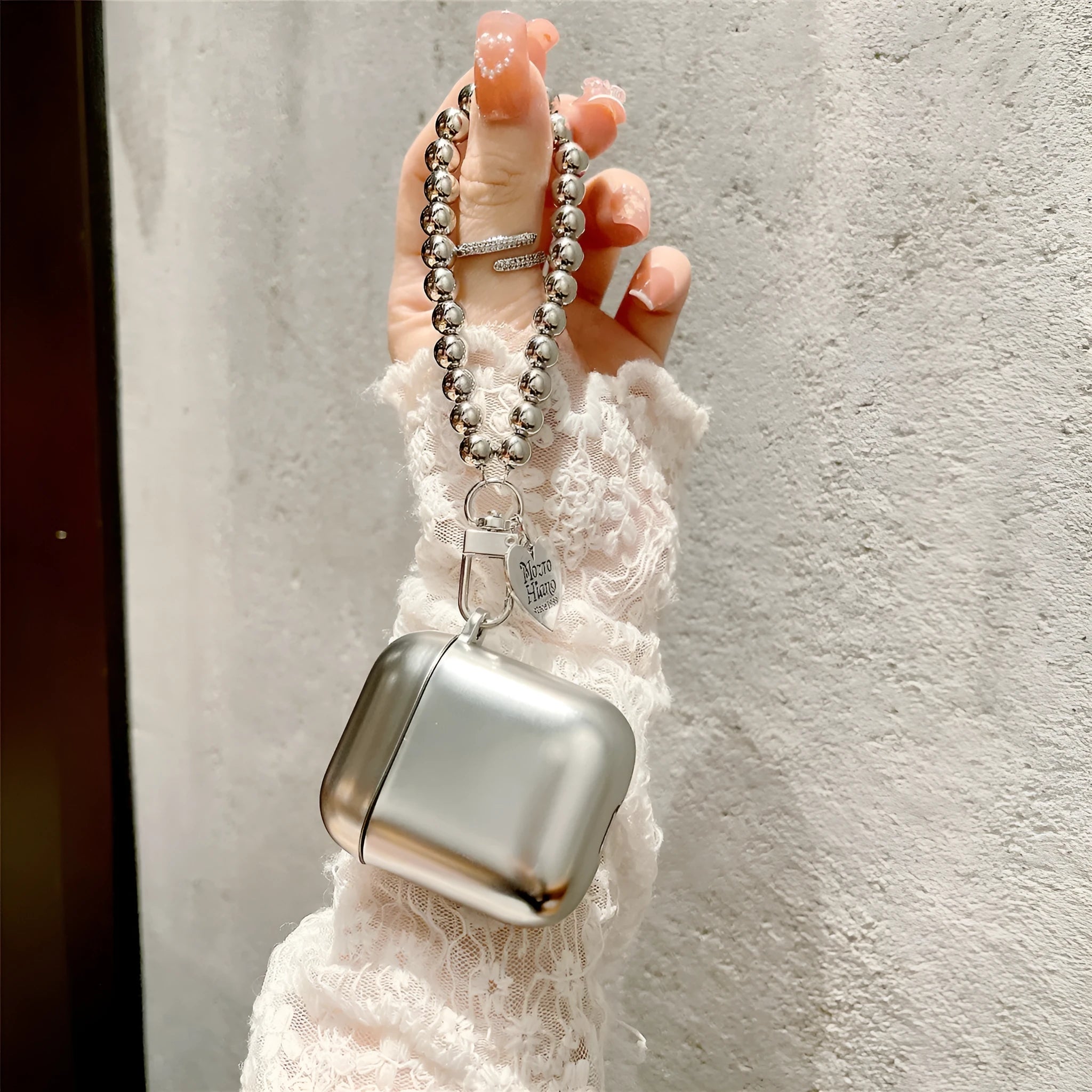 Matte plating TPU protective case for AirPods with an attached bracelet strap.