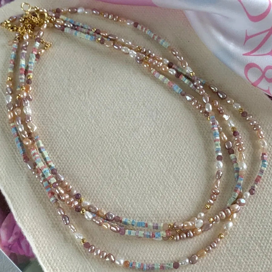 Natural silver pearl bracelet with 14K gilded purple finish and matching necklace on a U-shaped chain.