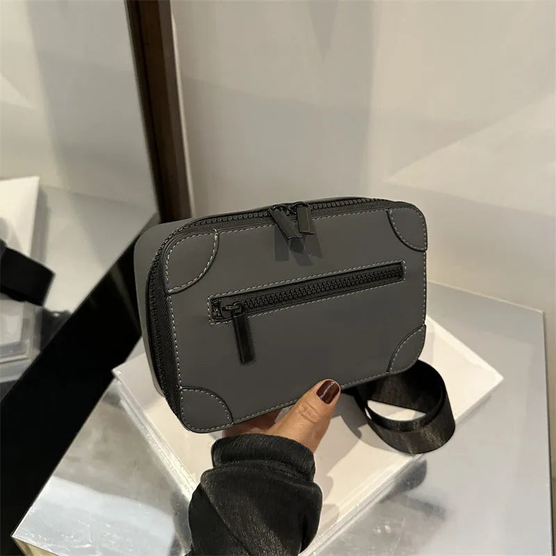 Small square black women's crossbody bag with single strap and external pockets