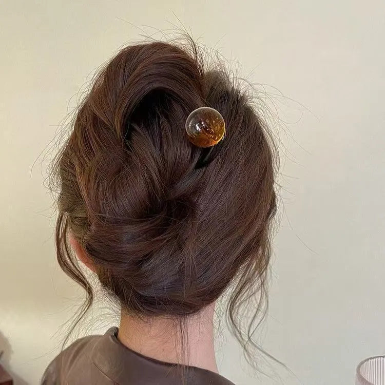 Acrylic U-shaped hair barrette with a retro ball design in a simple style.