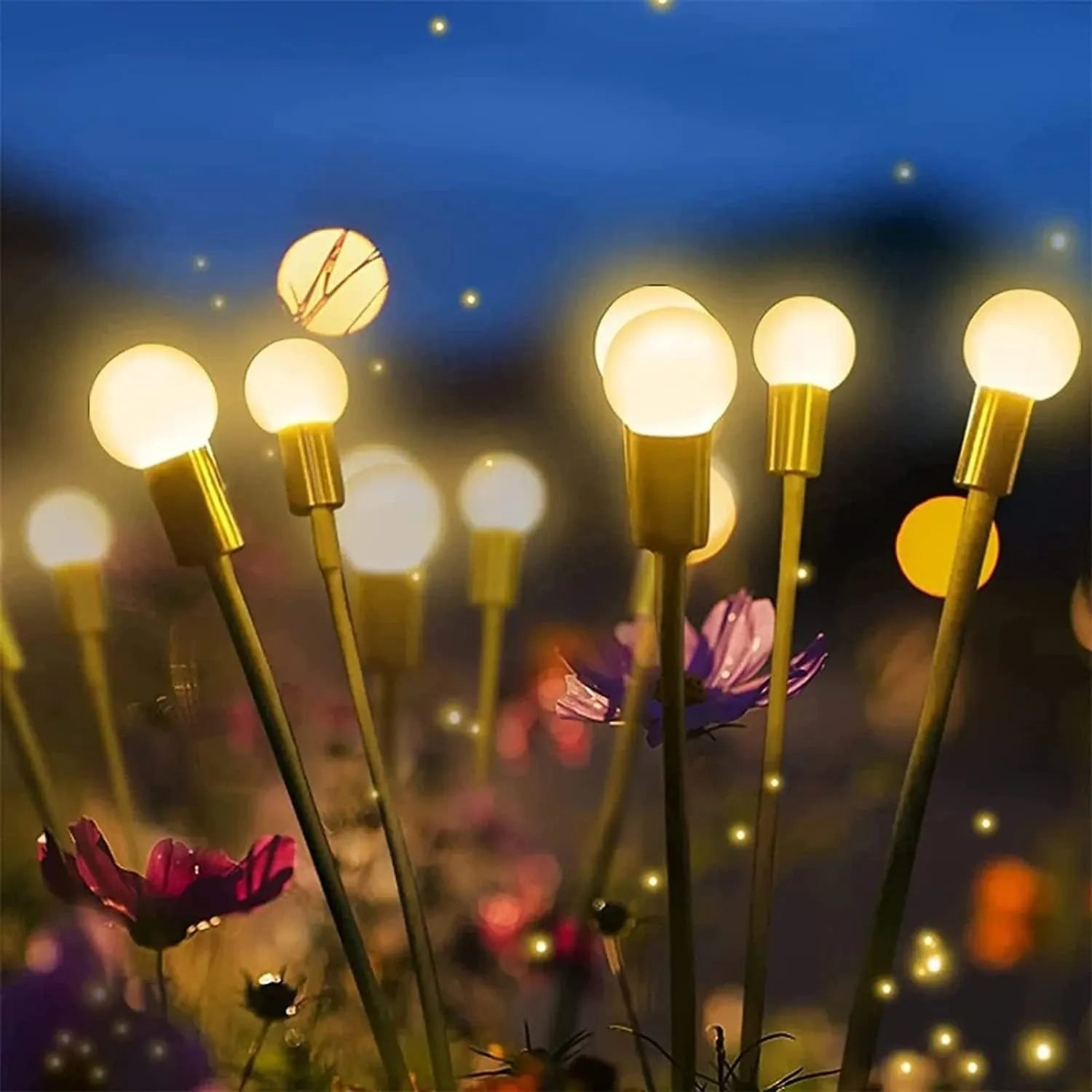Solar-powered LED garden ground light with stainless steel spike, lit up in a lawn at dusk.