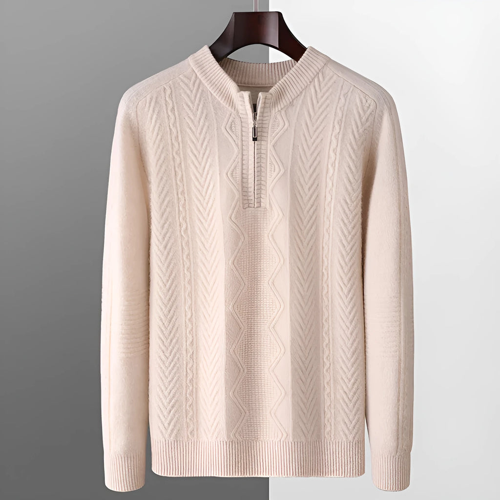 Man wearing a grey diamond pattern wool pullover sweater with a half-zip neck.