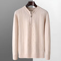 Man wearing a grey diamond pattern wool pullover sweater with a half-zip neck.