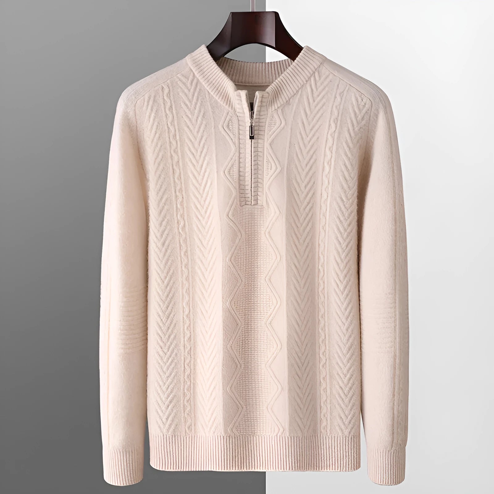 Man wearing a grey diamond pattern wool pullover sweater with a half-zip neck.