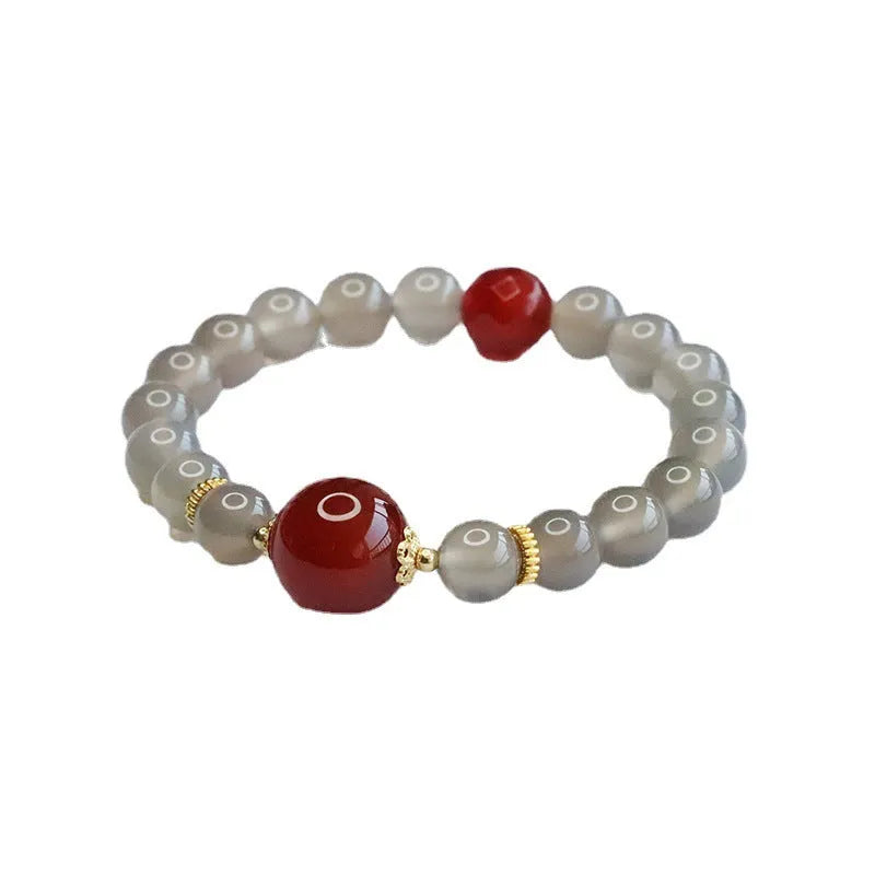 Smoky purple and red agate bracelet with 8mm geometric beads on a white background.