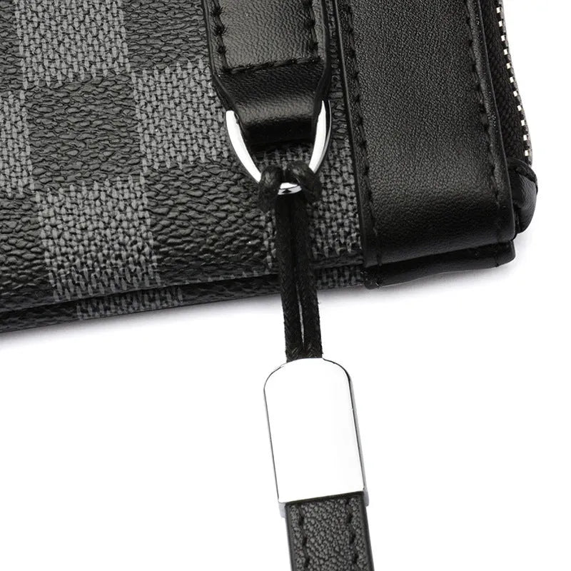 Black men's leather clutch wallet showing plaid lining, closed view