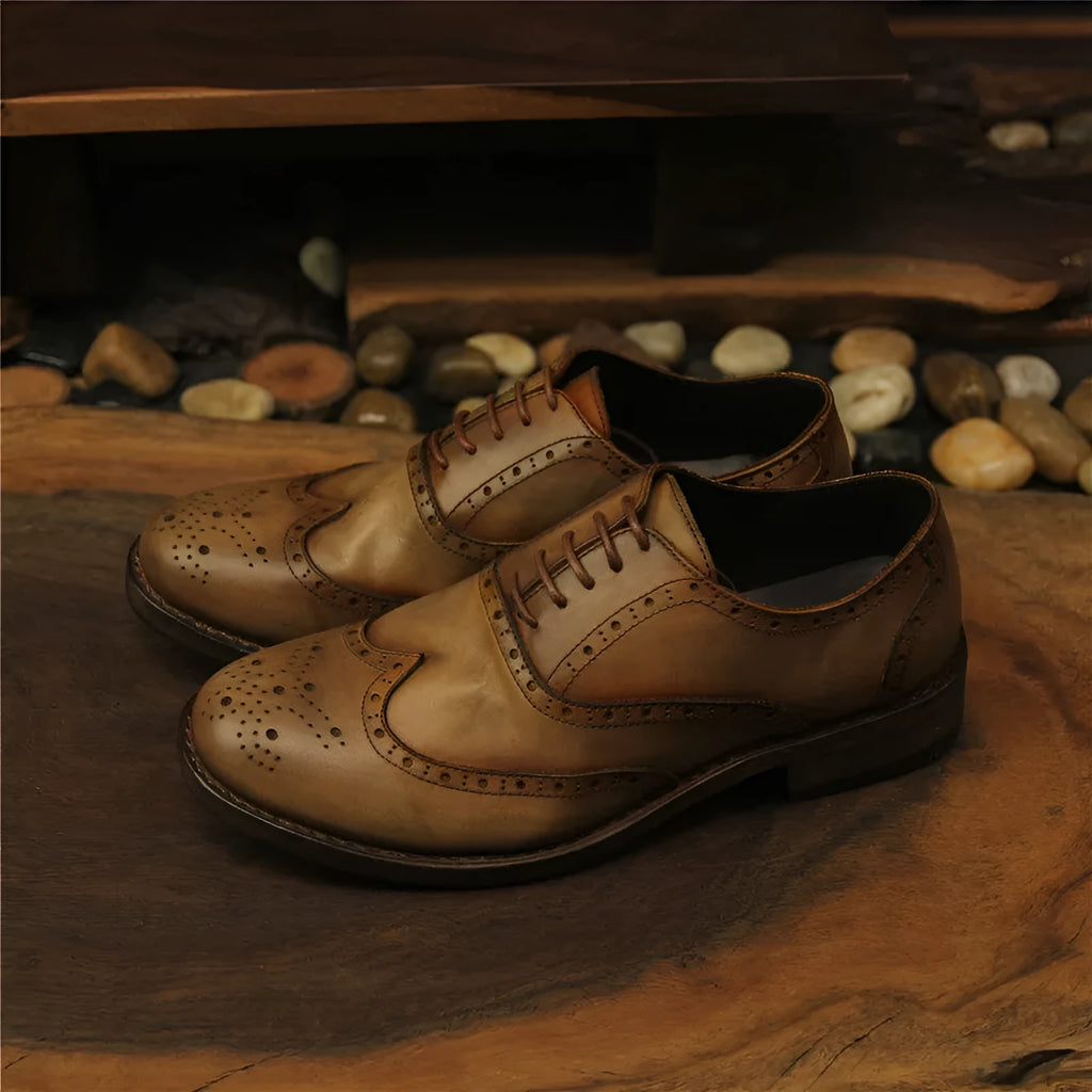 Light brown men's vintage casual leather shoes with hand-carved distressed detailing and a round toe.
