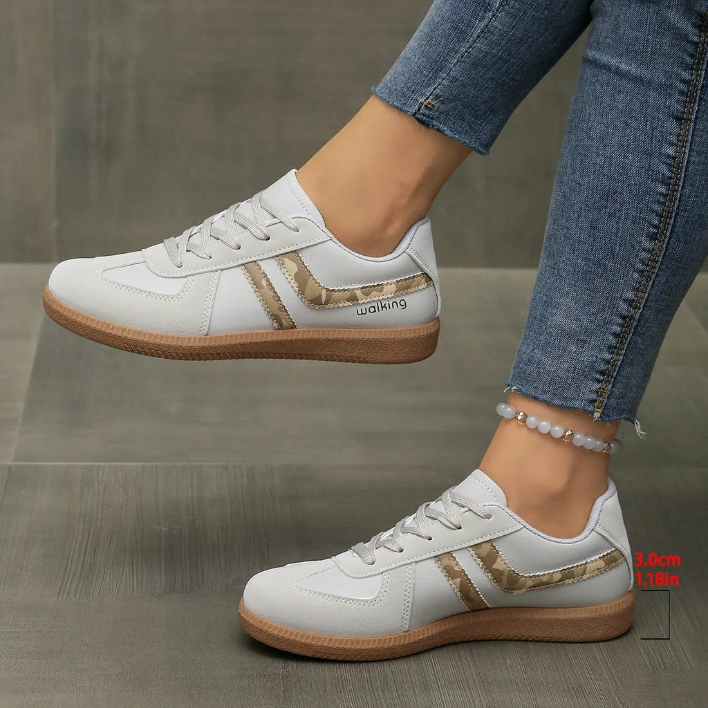 Women's low top casual sneaker in retro style with round toe and lace-up front.