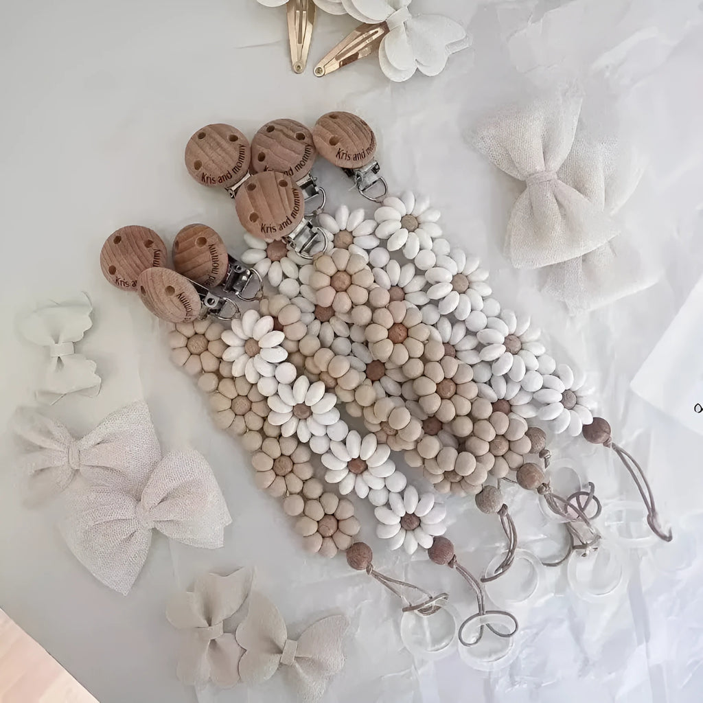 Baby flower silicone pacifier clip in pink on white background with custom name option