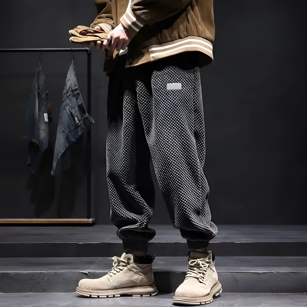 Grey men's sweatpants with ankle ties and a straight leg cut on a neutral background.