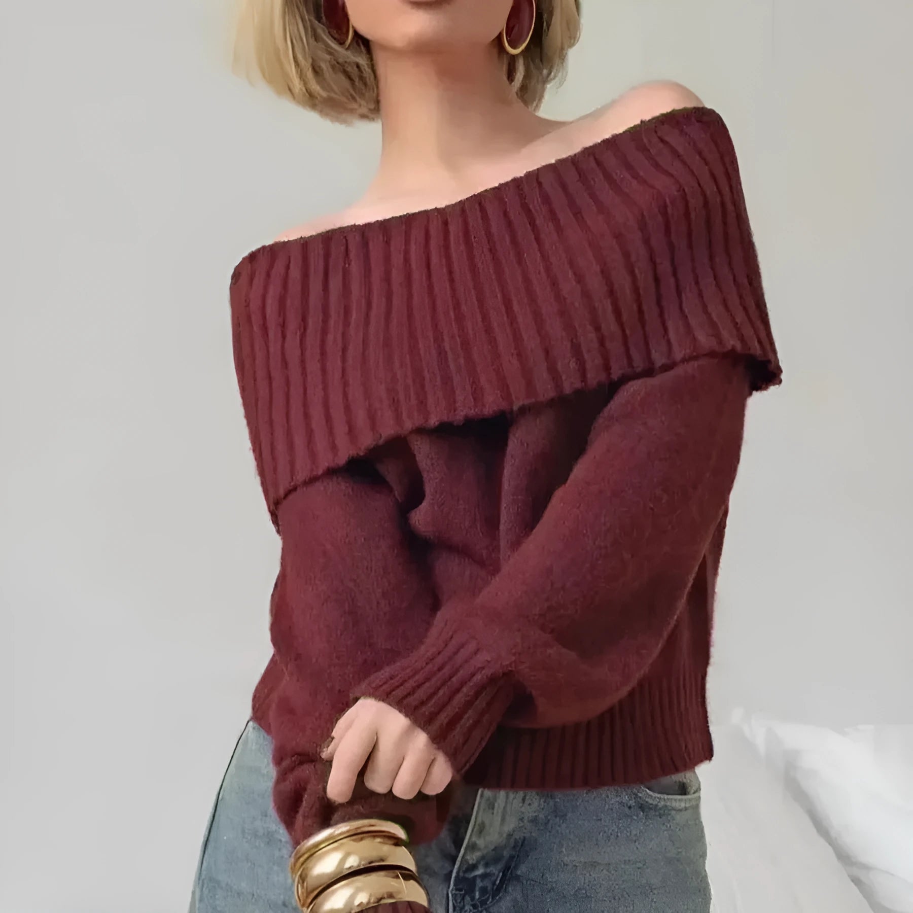 Grey off-the-shoulder sweater with a 3D pattern texture on the fabric.