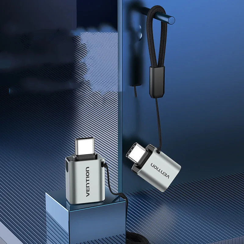 Grey aluminium alloy USB 3.0 Type-C Male to Type-A Female OTG adapter with attached lanyard.