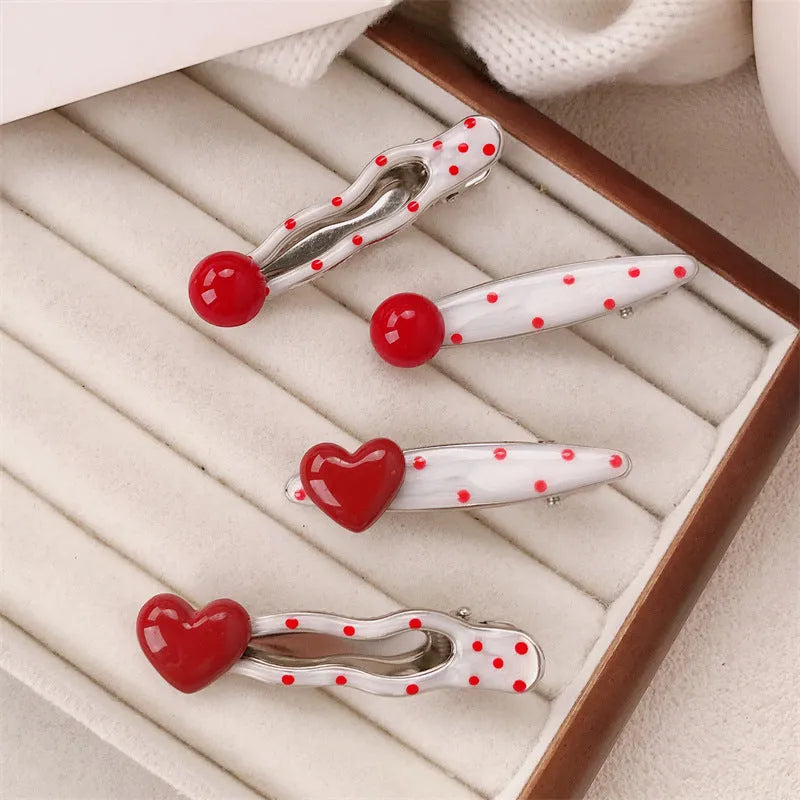 Red heart-shaped hair clip with retro dot patterns and willow leaf clip design