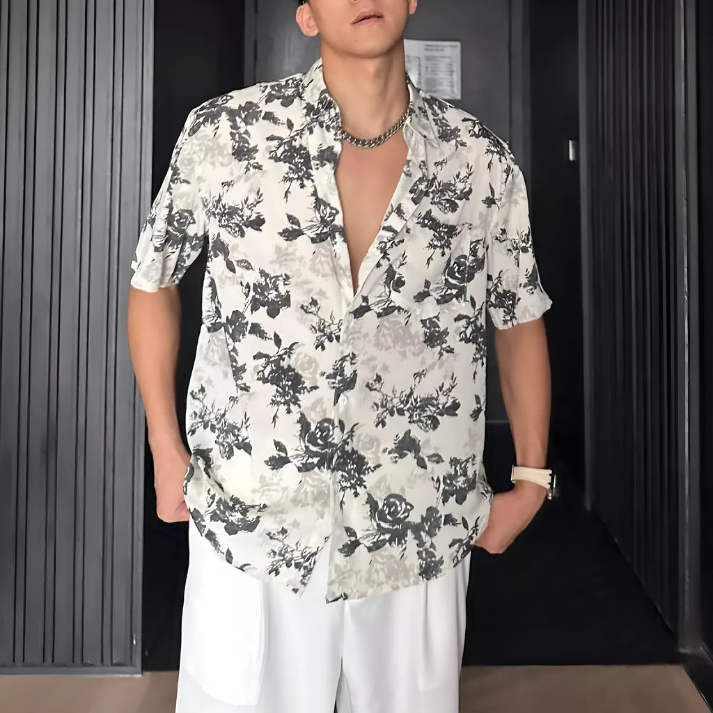 Man's loose black short sleeve shirt with a white floral print pattern.